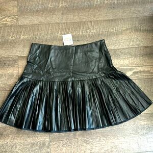 Black faux leather, pleated skirt.